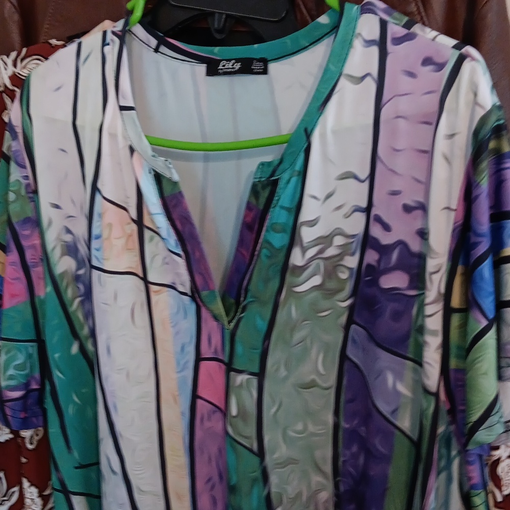 A Lily muti-colored dress is 2XL.she is green purple blue yellow white & black